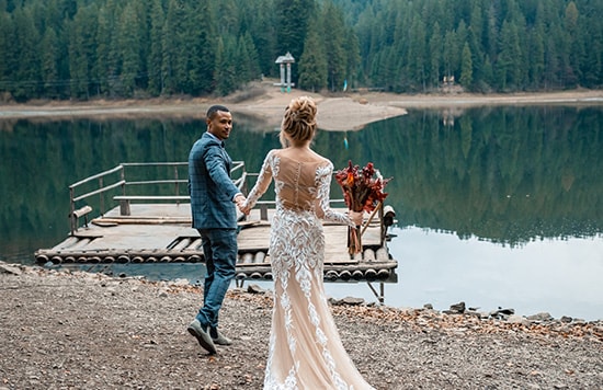 bride and groom enjoying time alone by the lake How to Stay for Free with a Hotel Credit Card