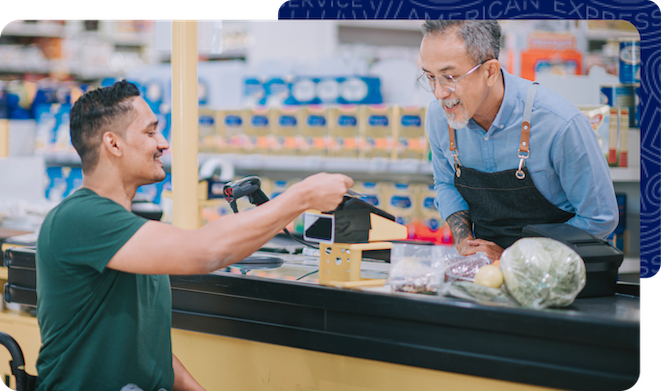 Man in wheelchair making a purchase at the grocery store with his credit card